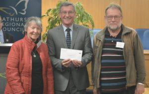 Photo of Sr Bernie Evens and Barrie Stephens accepting the cheque from Mayor Cr Gary Rush.